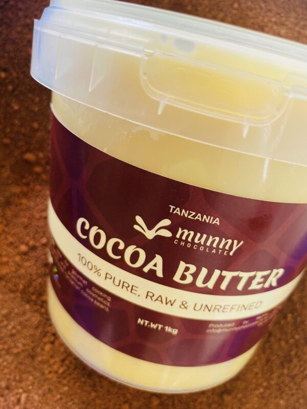 Hand holding premium Tanzania raw and unrefined cocoa butter