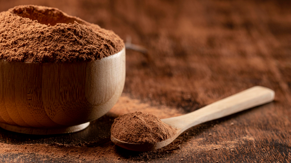 Natural Premium Tanzania Cocoa Powder in wooden bowl.