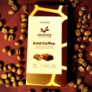 Bold Coffee 70% Tanzanian Dark Chocolate bar surrounded by roasted coffee beans