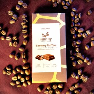 Creamy Coffee 45% Tanzanian Milk Chocolate bar surrounded by coffee beans